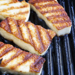 Halloumi cheese frying in grill pan.